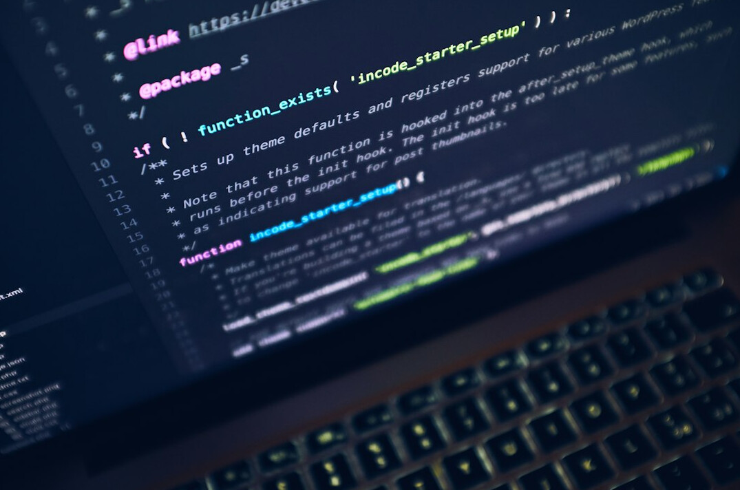 person coding at home desk